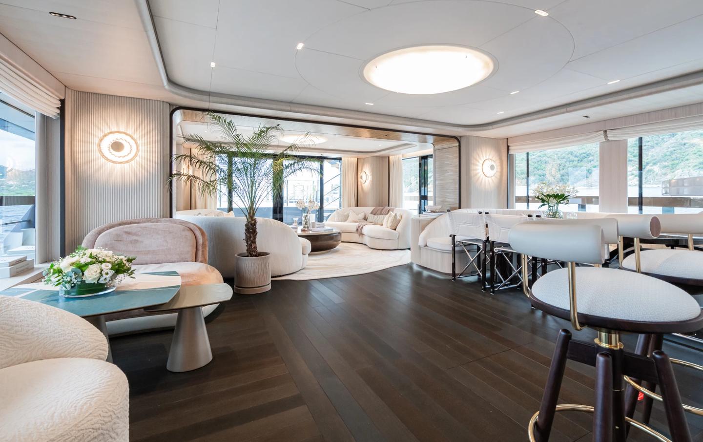 Superyacht M's central bar and lounge space with dark wood features 