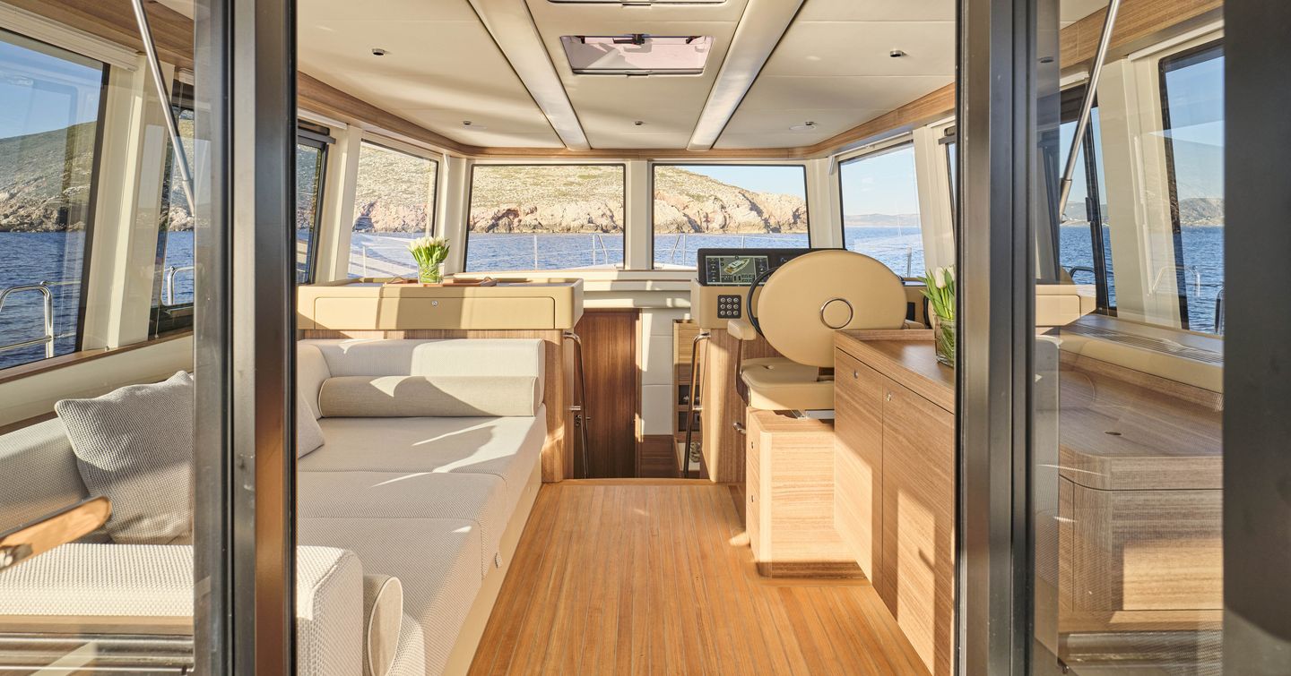 Omikron OT-60 motor yacht upper saloon with cream sofa and helm station