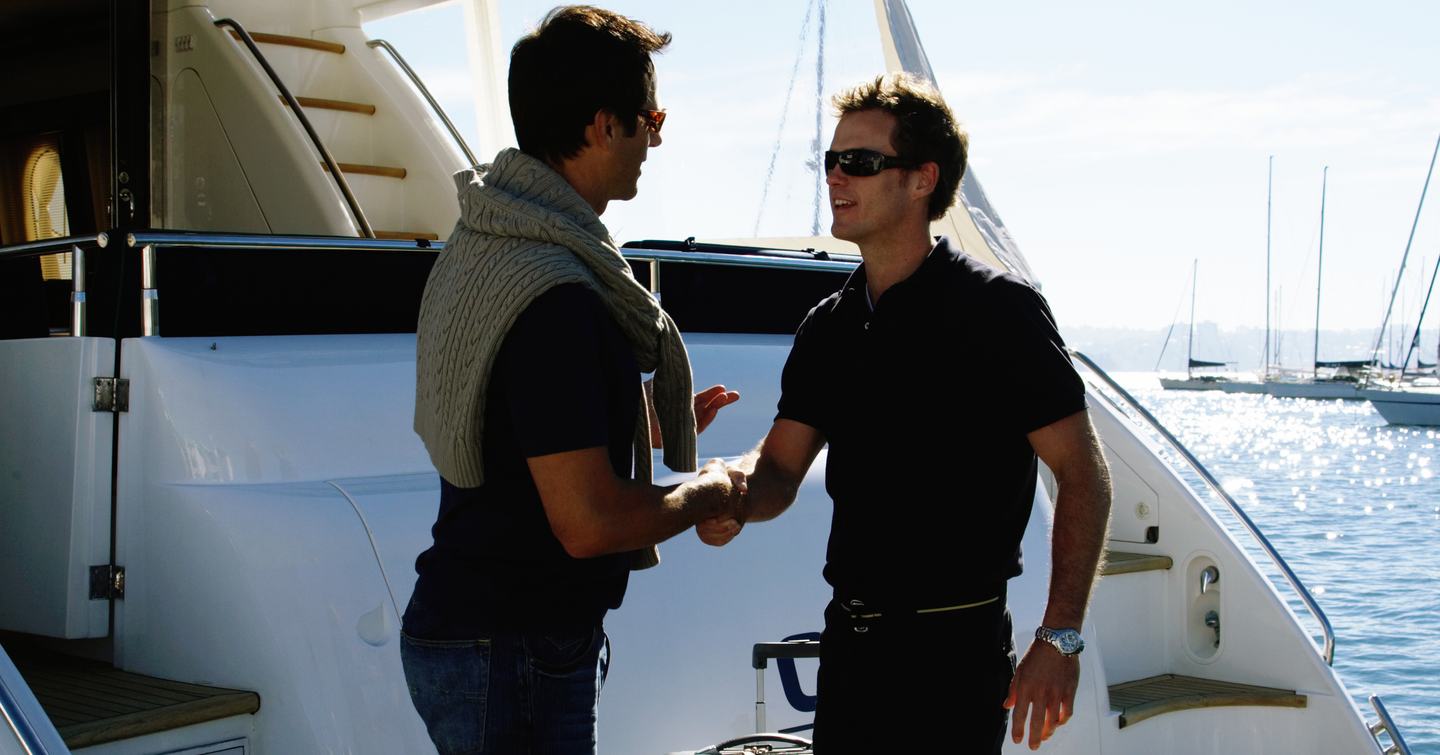 Yacht owner and yacht captain shaking hands