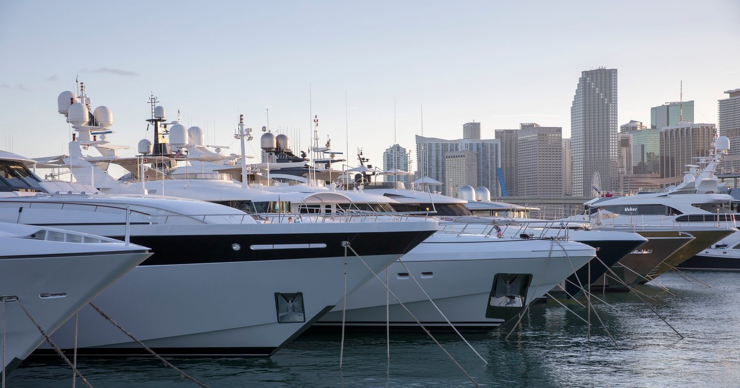 Boats lined up with large buildings in background