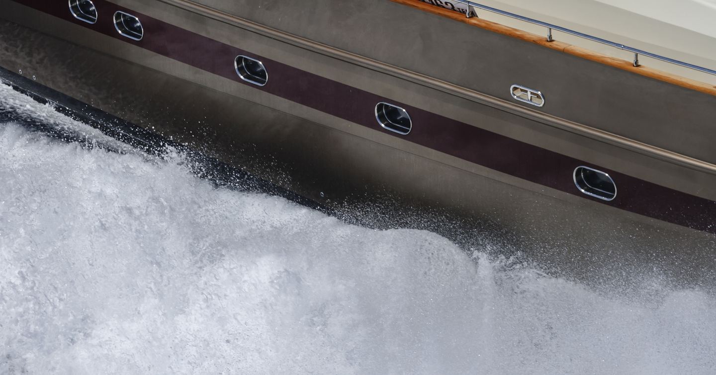 Water splashing against yacht hull while underway 