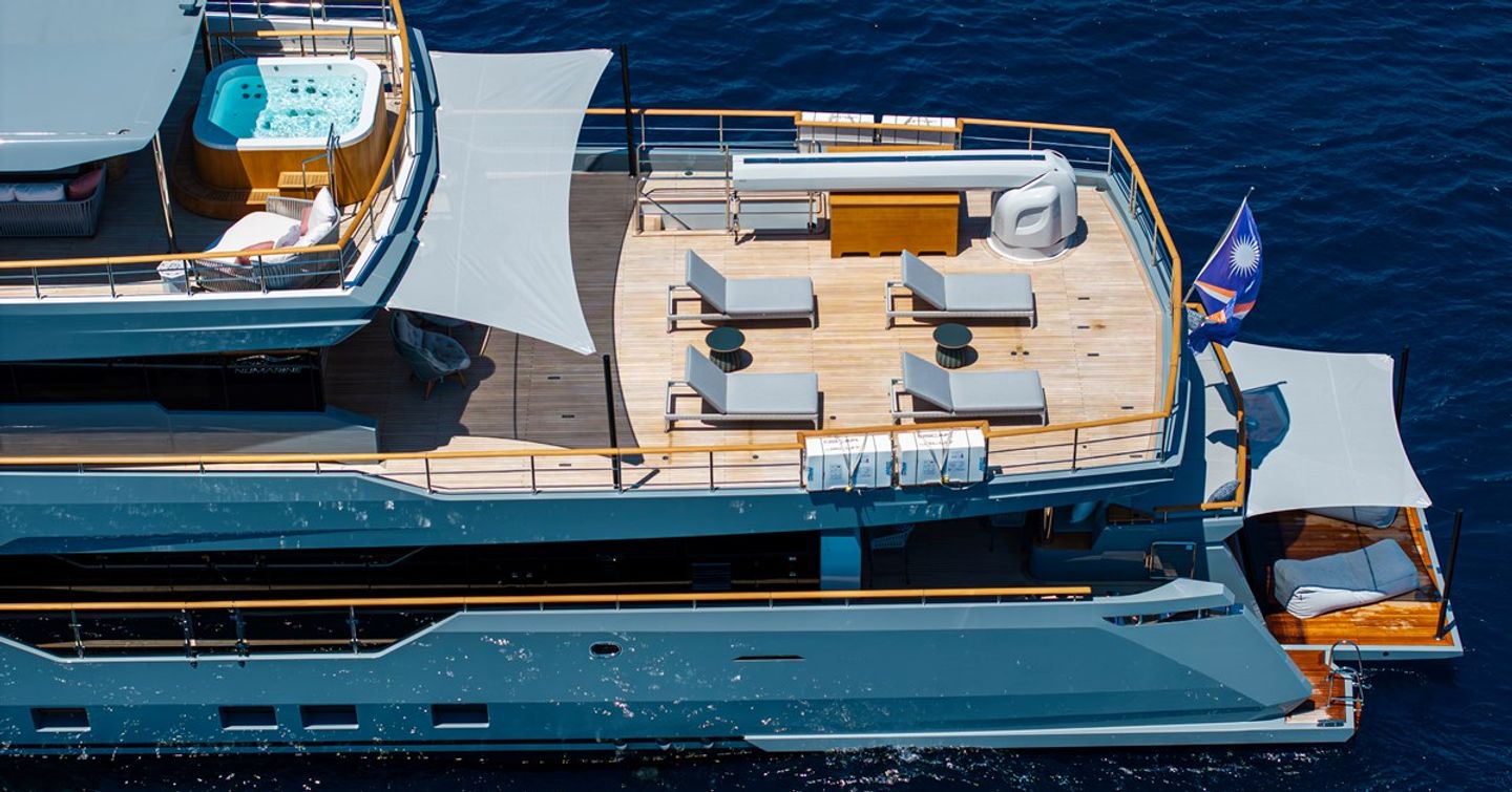 Aerial view of Superyacht Oscar's aft decks with jacuzzi, sunloungers and shaded beach club