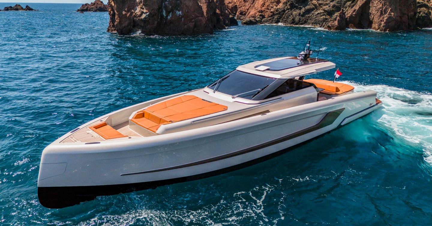 WiLder 60 boat floating in front of rocks in a calm sea