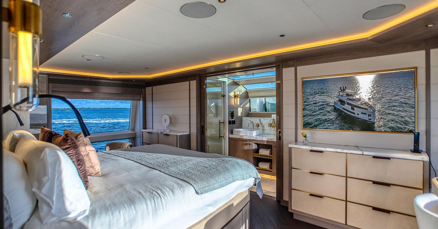 Motor Yacht Saint master cabin with large windows, modern finishes and ensuite bathroom