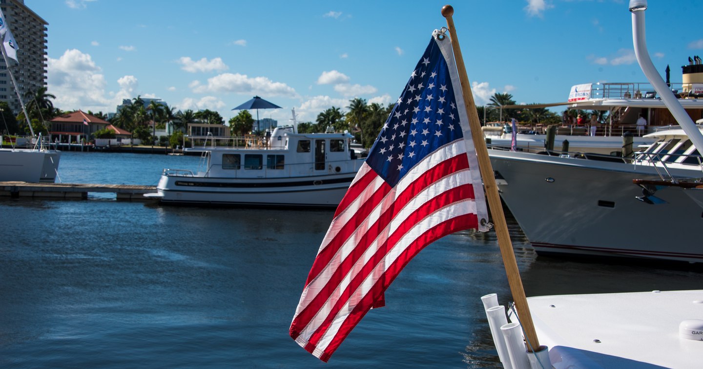 American flag in front of yachts