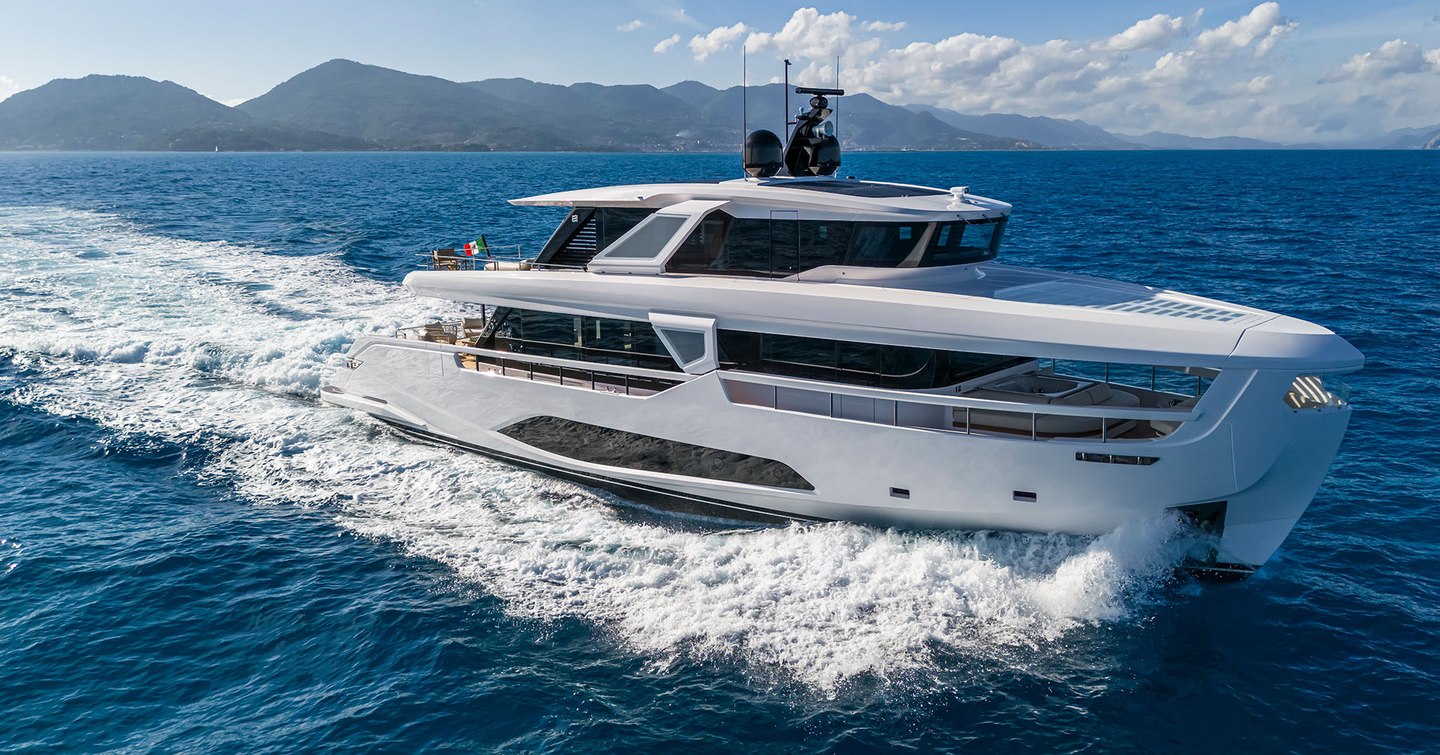 INFYNITO 90 running through choppy blue seas showing its extensive glazing on the starboard side