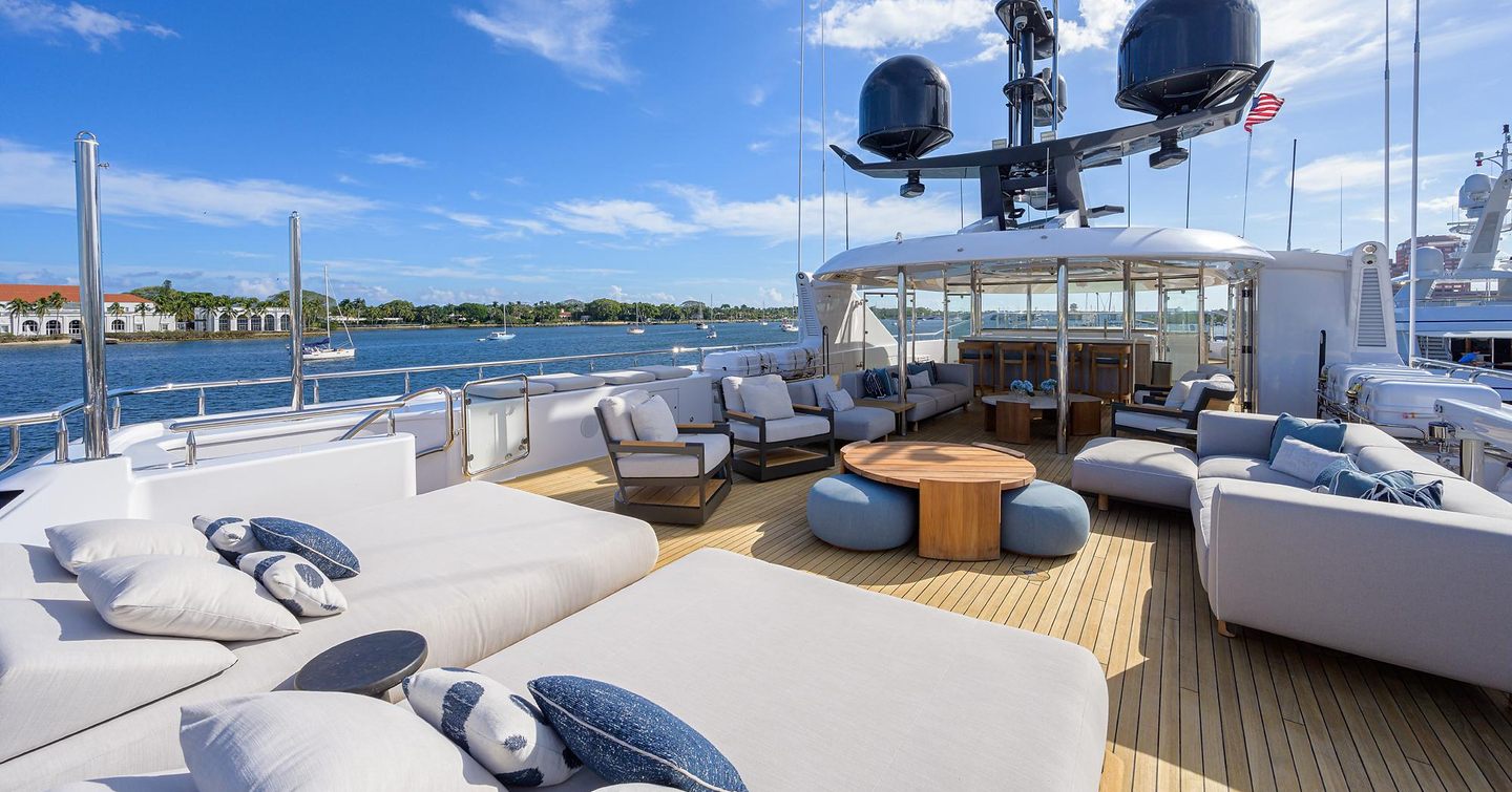 Overview of the upper deck onboard the superyacht Quantum of Solace. Sun pads in foreground with seating aft.