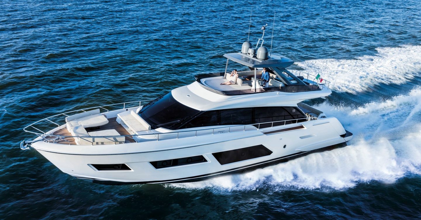 A Ferretti 670 running through an flat blue sea, showing its port side and large bow seating area