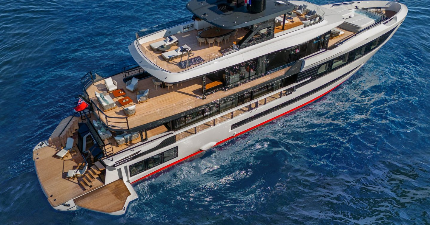 Mangusta Oceano 39 aerial show over starboard side, from quarter deck. Yacht is stationary as side deck wings are fully open to extend the bathing platform and beach club area, calm waters