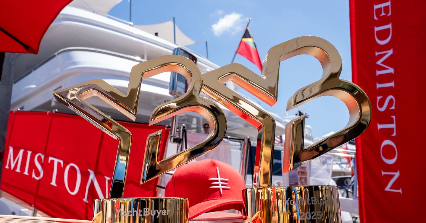 Close up of two gold YachtBuyer Broker Awards on Edmiston stand at PBIBS 