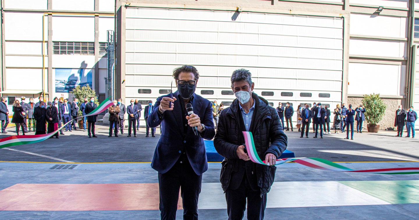 Two men cutting ribbon on opening of new shed