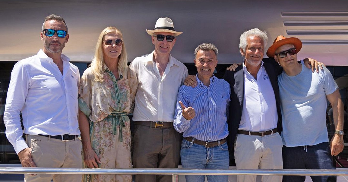 Silent Yachts team standing in front of SY80 catamaran
