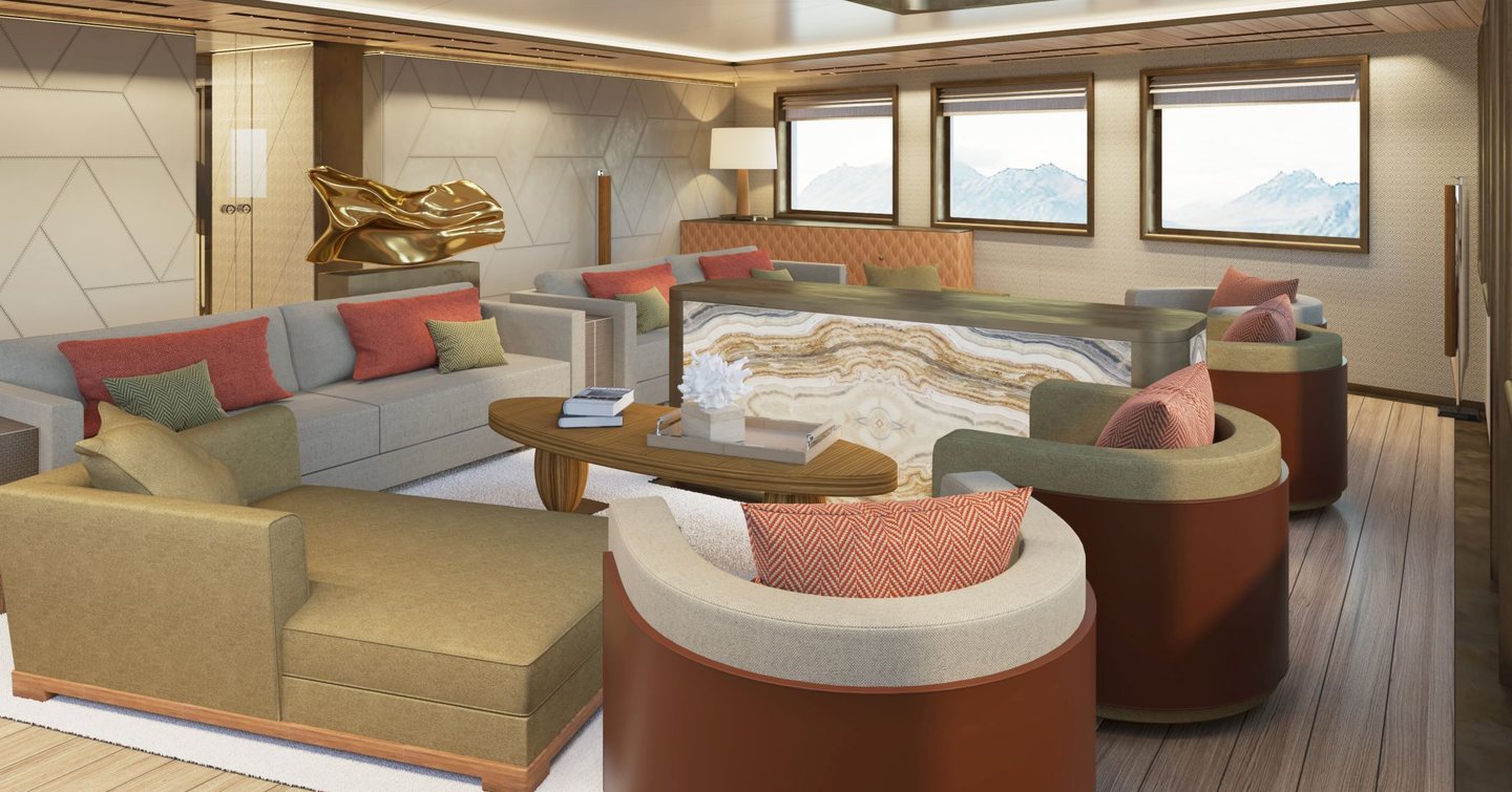 Lightly colored interior of Damen Yachting's 'La Datcha' Explorer Yacht, consisting of series of armchairs and sofas around a small wooden table with windows in the background