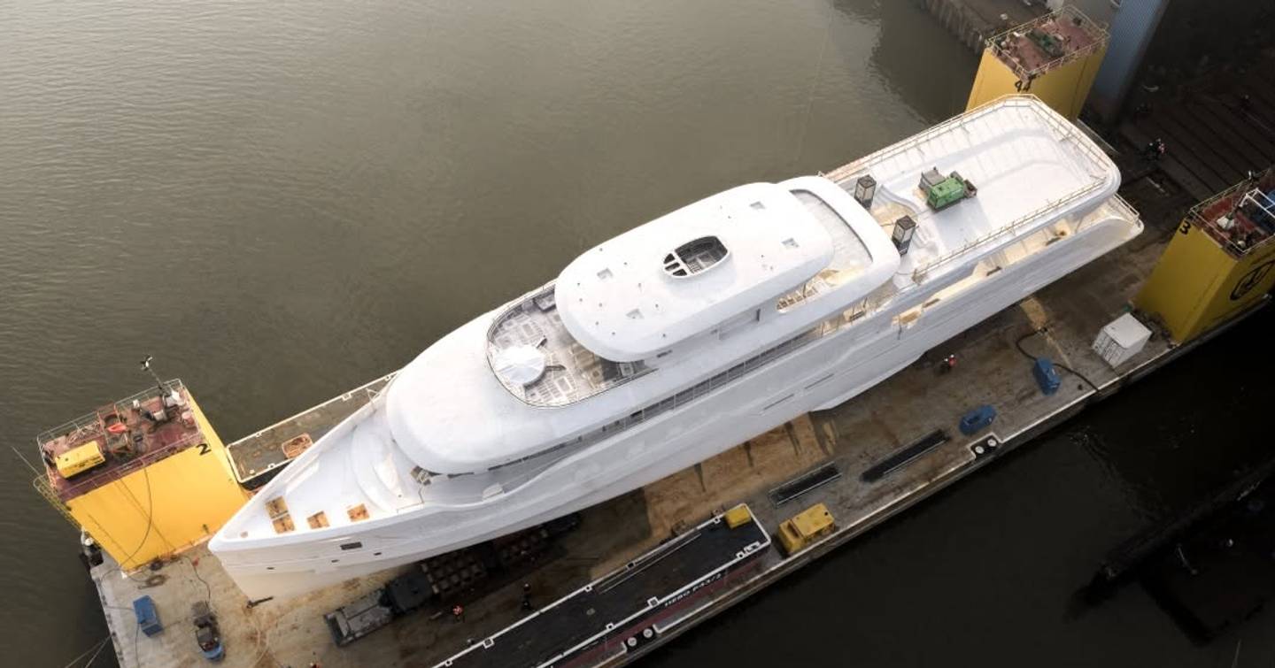 Aerial view of superyactht Feadship 719 outside shipyard pre-outfitting