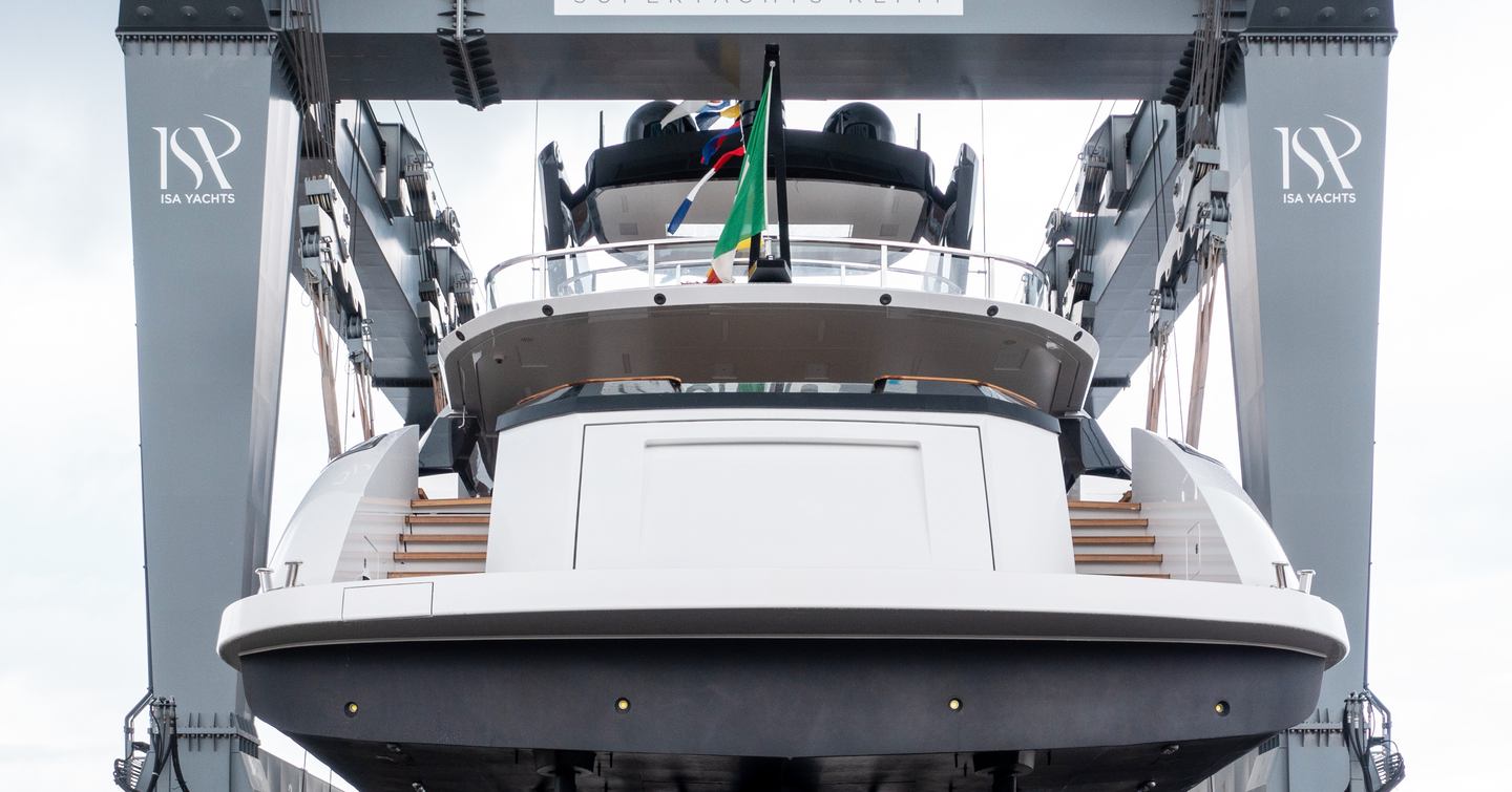 Aft view of M/Y UV II elevated off the ground on a crane during the christening ceremony at Ancona.