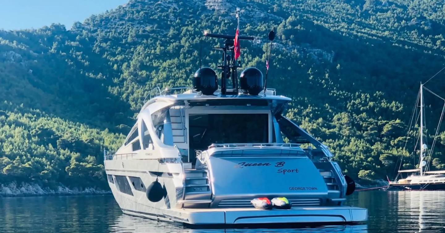 Pershing motor yacht Queen B Sport at anchor stern view 
