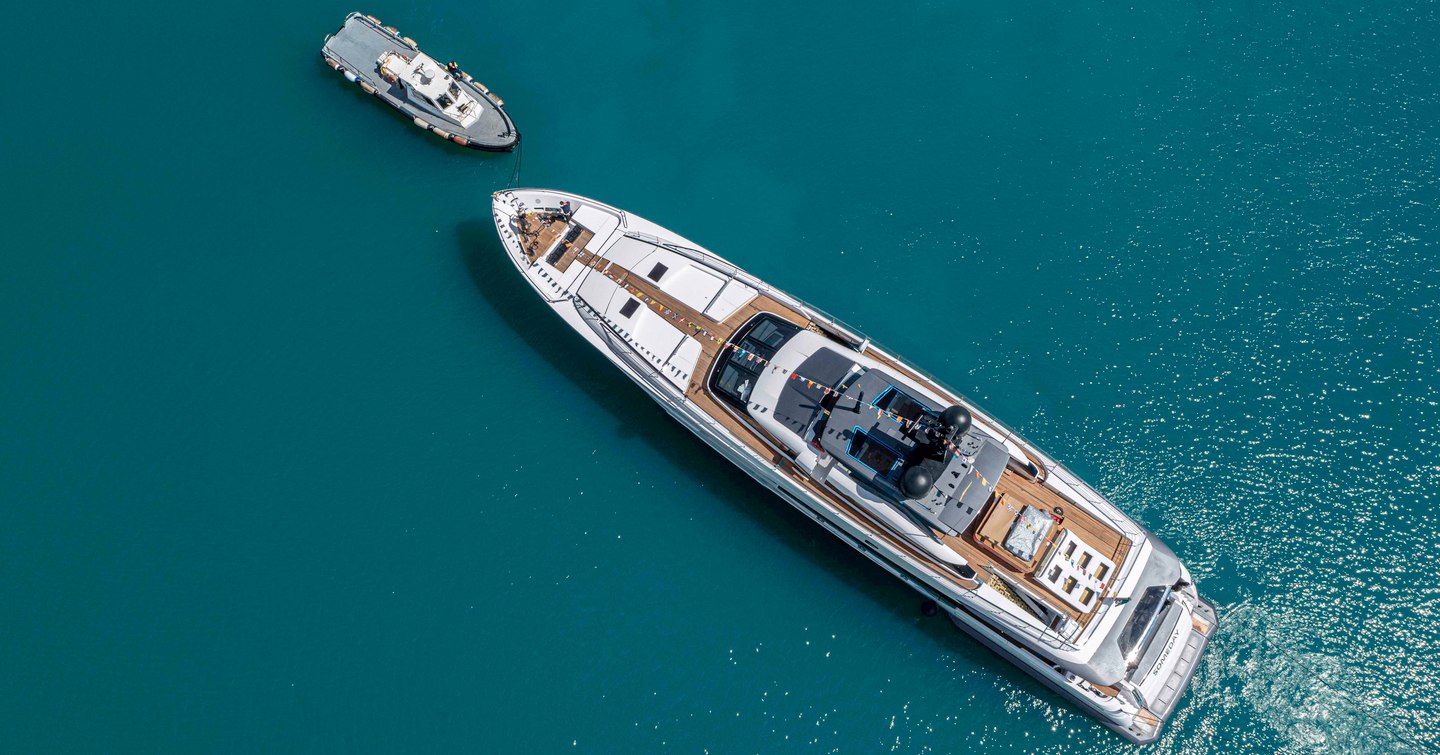 Aerial bird's eye view of M/Y SOMEDAY, surrounded by sea with a tender facing her bow.