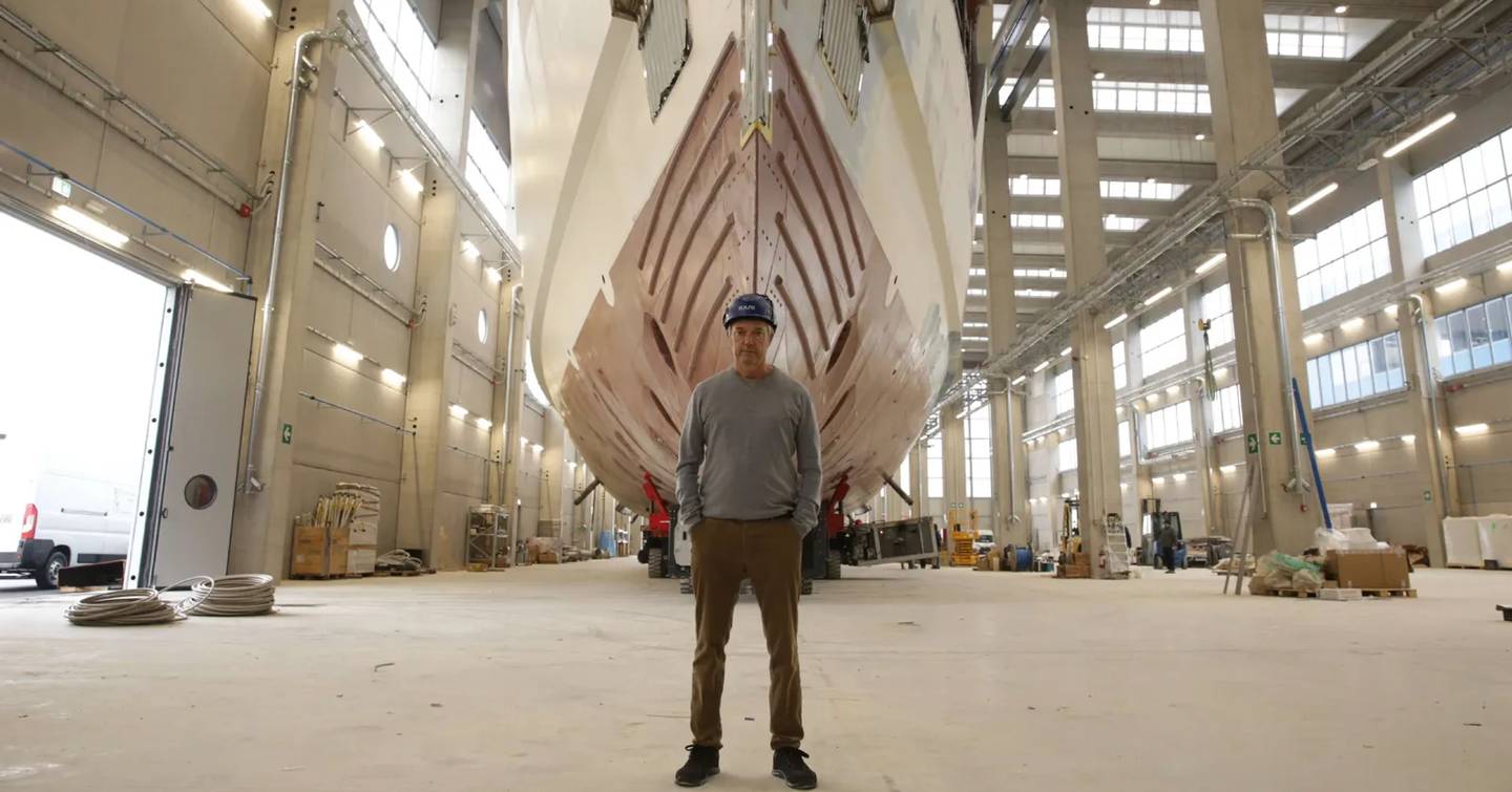 CEO of Amer Yachts Rodolfo Amer standing in front of Flagship Amer 74 Steel superyacht hull in shipyard