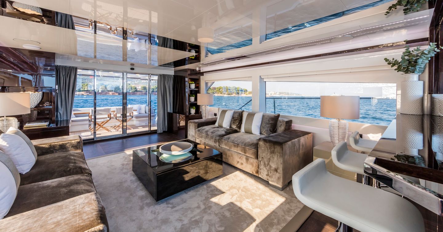 Interior of Pearl yacht with sofa, comfortable seats and expansive windows