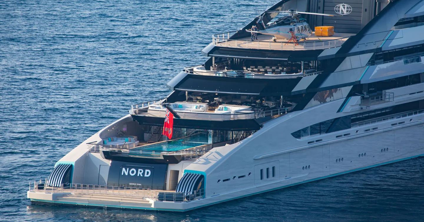 Close up of Superyacht Nord aft decks with large infinity pool and multiple seating areas 