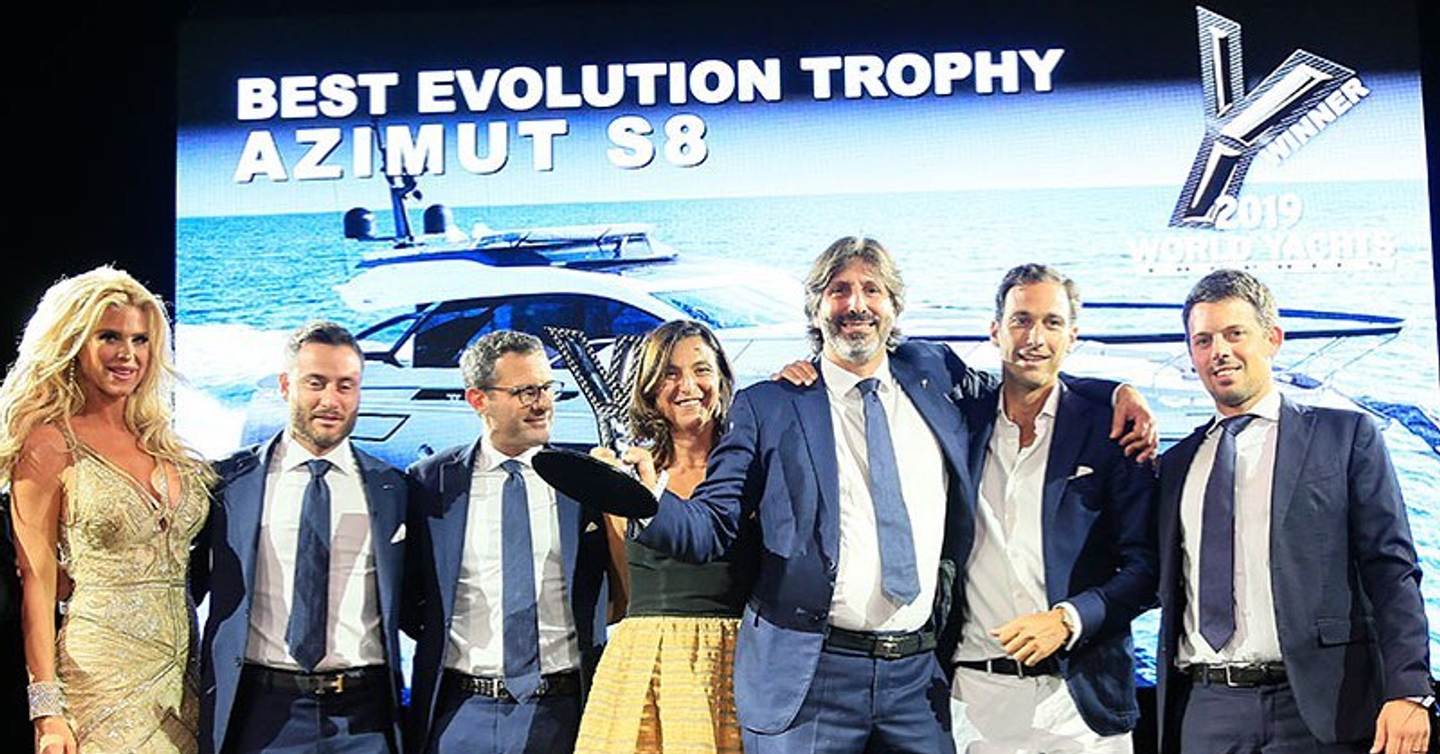World Yachts Trophies winners on stage with trophy