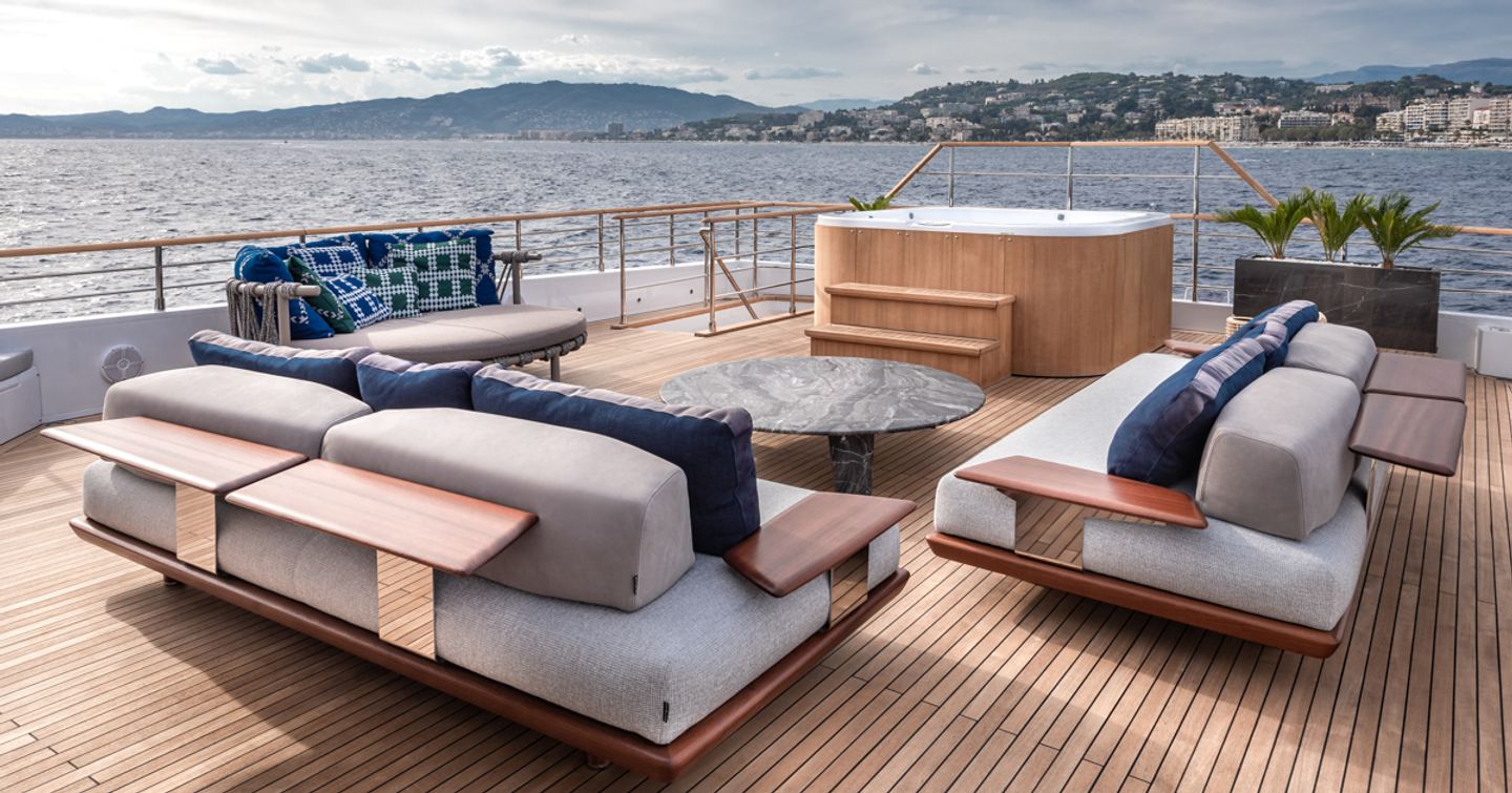 Comfortable sofas and table with Jacuzzi in background on Numarine 37XP