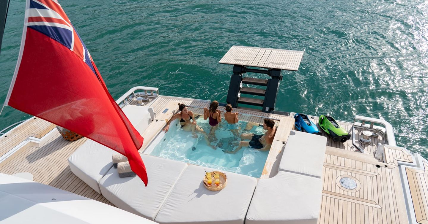 Family on superyacht A+'s aft deck having fun in the pool