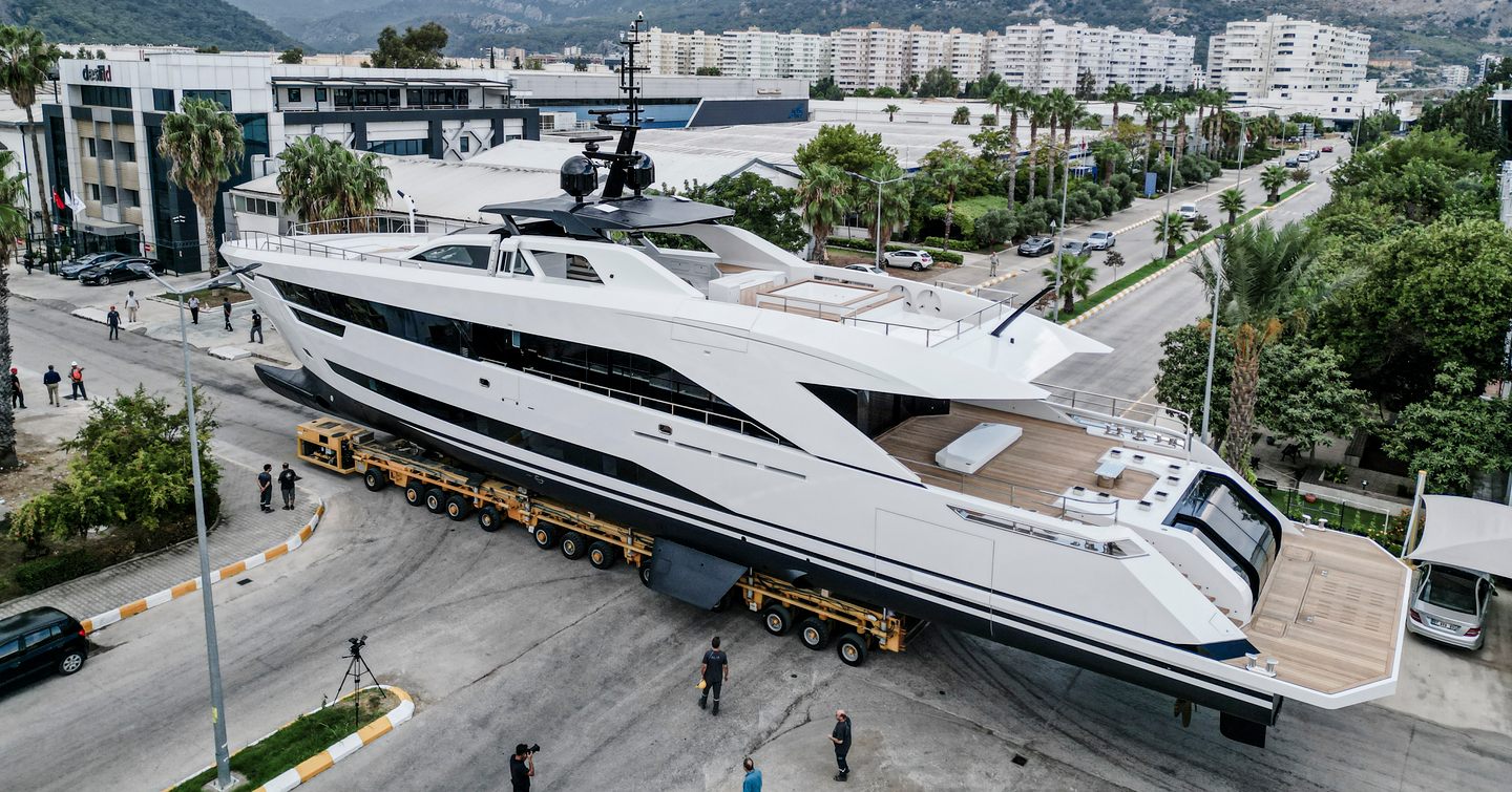 Superyacht Ximena crossing a road on a trolley on the way to her launch