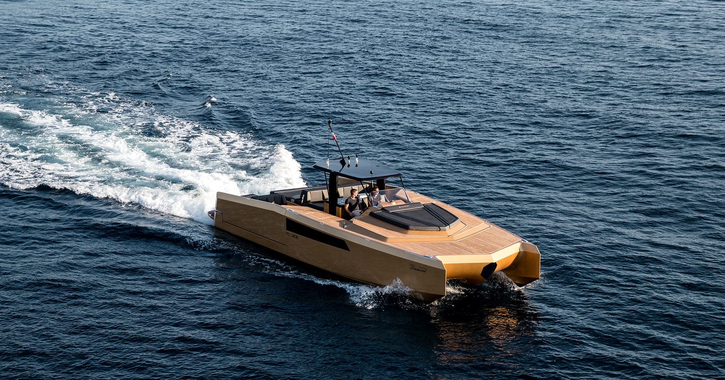 Teak exterior of Sunreef Yachts 40 Open Power being driven at speed across water with two people at helm