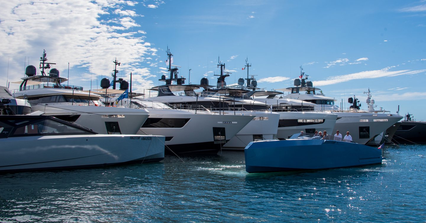 Line of motor yachts moored on display at Cannes Yachting Festival.