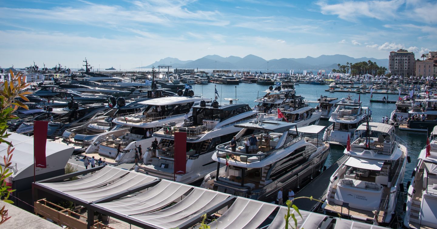 Overview of Vieux Port during the Cannes Yachting Festival. Many motor yachts berthed.