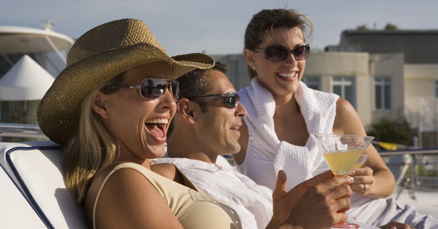 Friends laughing and relaxing on a yacht  