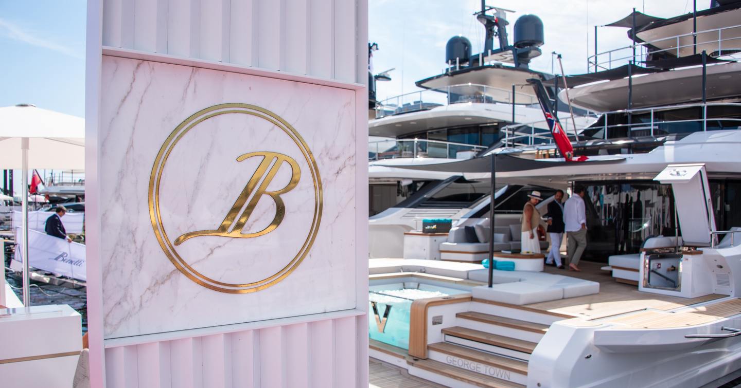 Benetti flag and stand at Cannes Yachting Festival, in front of yacht Viva, bright day