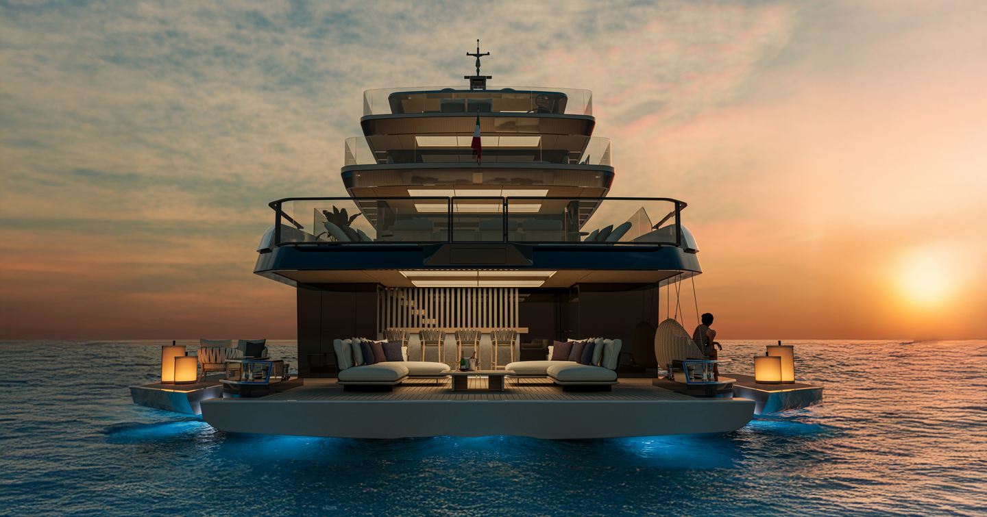 Extra X145 Global motor yacht stern view at sunset with beach club and underwater lights.