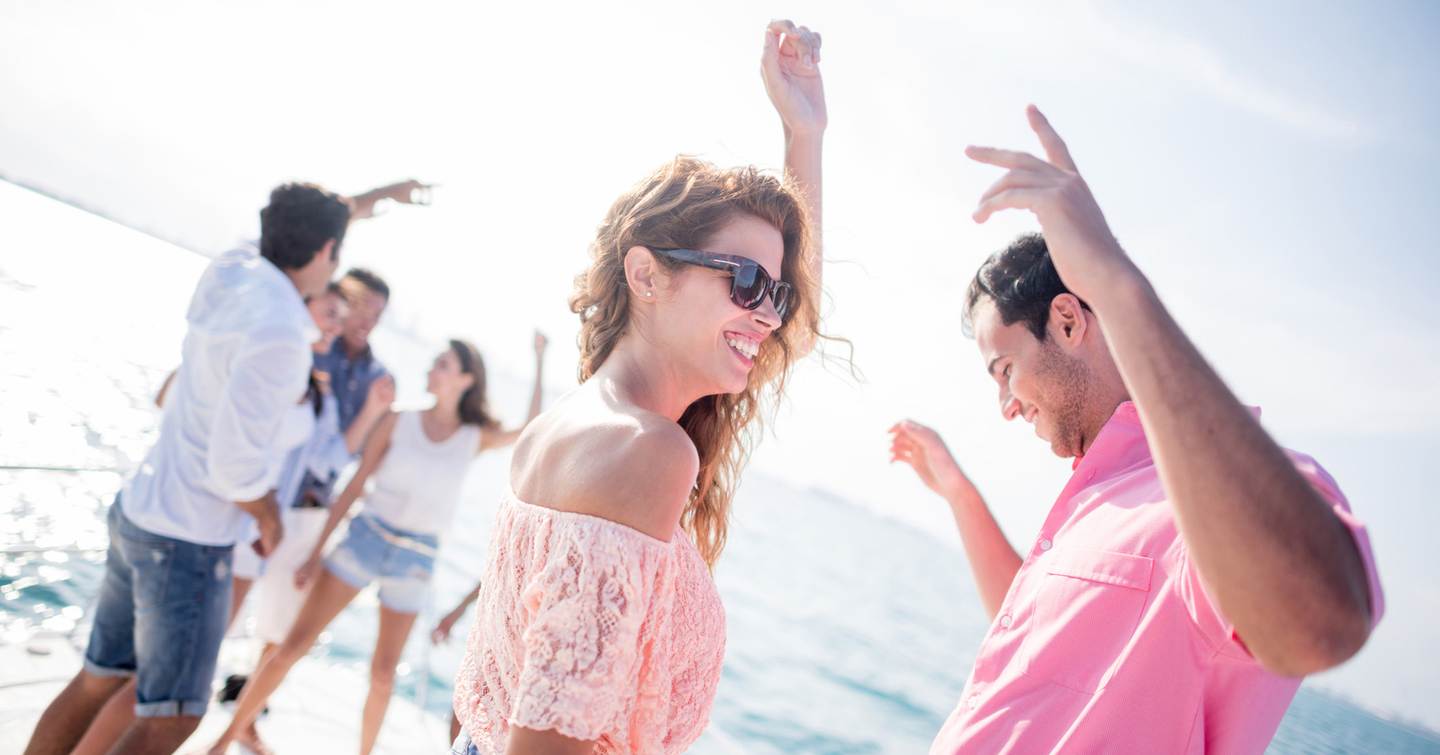 Friends dancing on a yacht together 