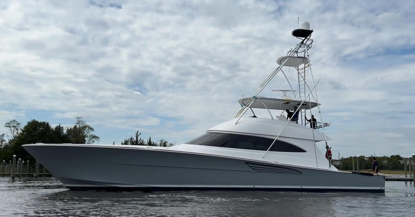 A port-side view of the Viking 74C sportsfisher showcasing a dark grey hull