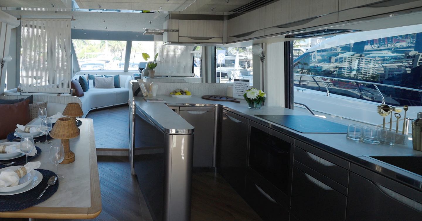 Open-plan galley aboard the Galeon 620 Fly with island workspace and panoramic glazing.
