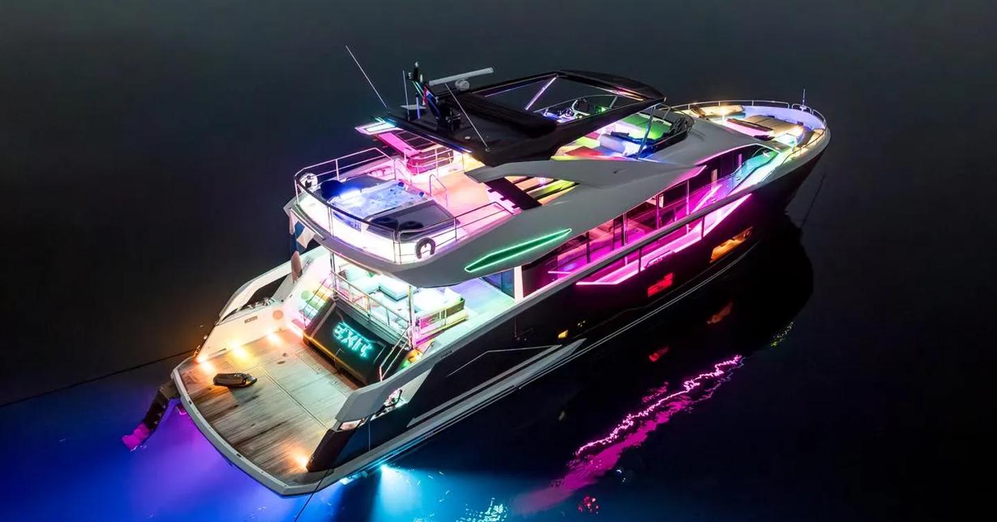 Sunseeker motor yacht Exit at anchor stern view with colourful lights 