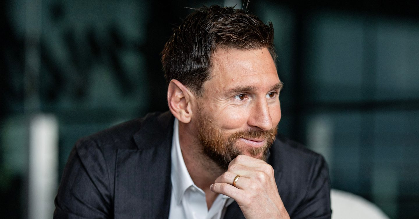 Lionel Messi sat smiling 