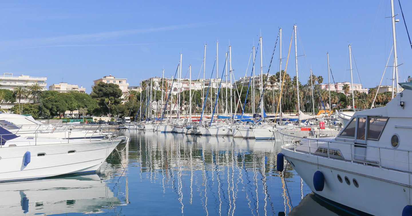 Overview of Port Canto in Cannes, many sailing boats berthed.