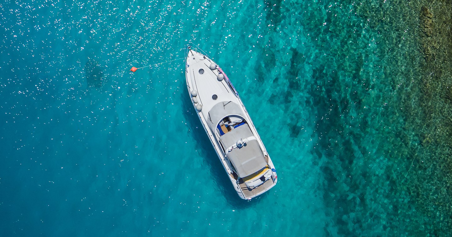 Yacht at anchor in shallow waters 