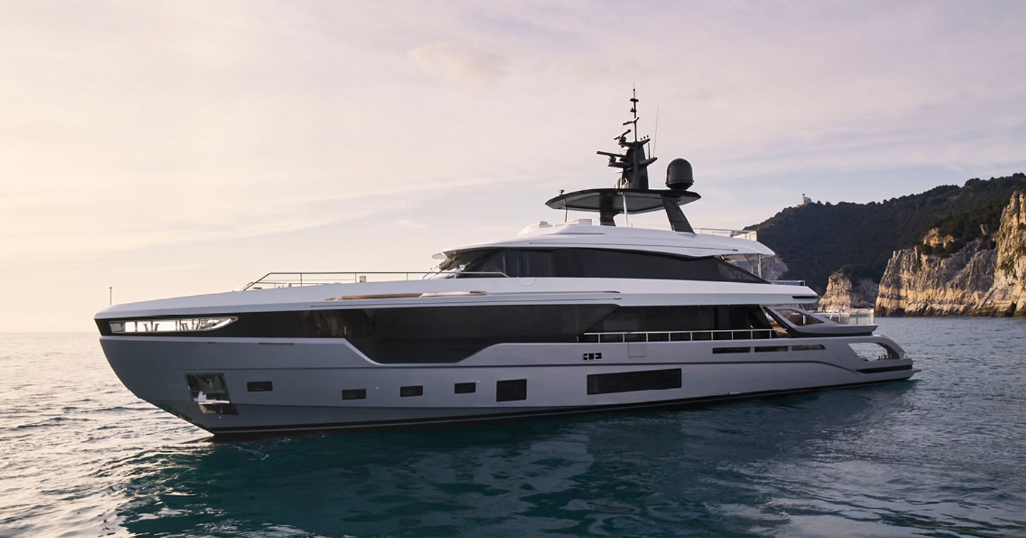 Azimut Grande Trideck SHABBY on water with coastline behind