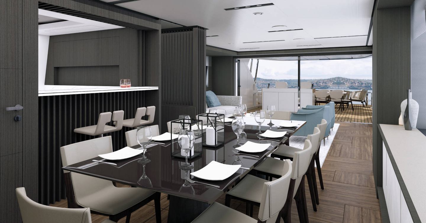 Interior dining option onboard Pershing GTX116. Long black table surrounded by chairs, overlooking lounge area in the exterior environment.