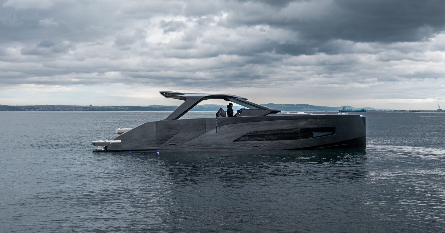 Manari 52 boat on calm waters with storm clouds above
