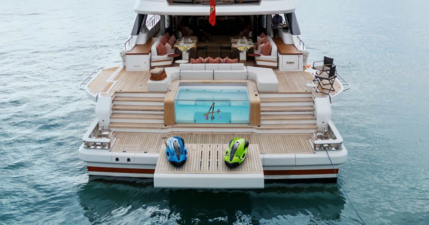 Superyacht A+'s bridge deck with freestanding furniture, glass plunge pool and sea toys