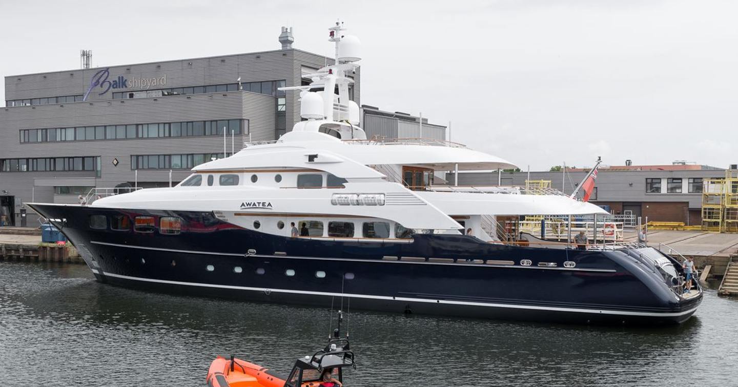 Superyacht Awatea docked outside Balk Shipyard next to tugboat 