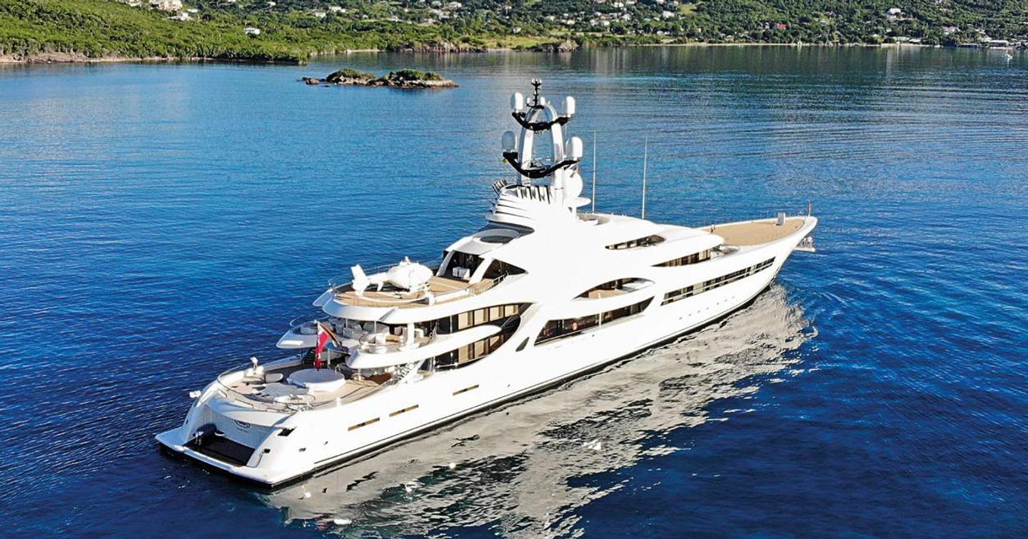 Superyacht ANNA on water with hills in background