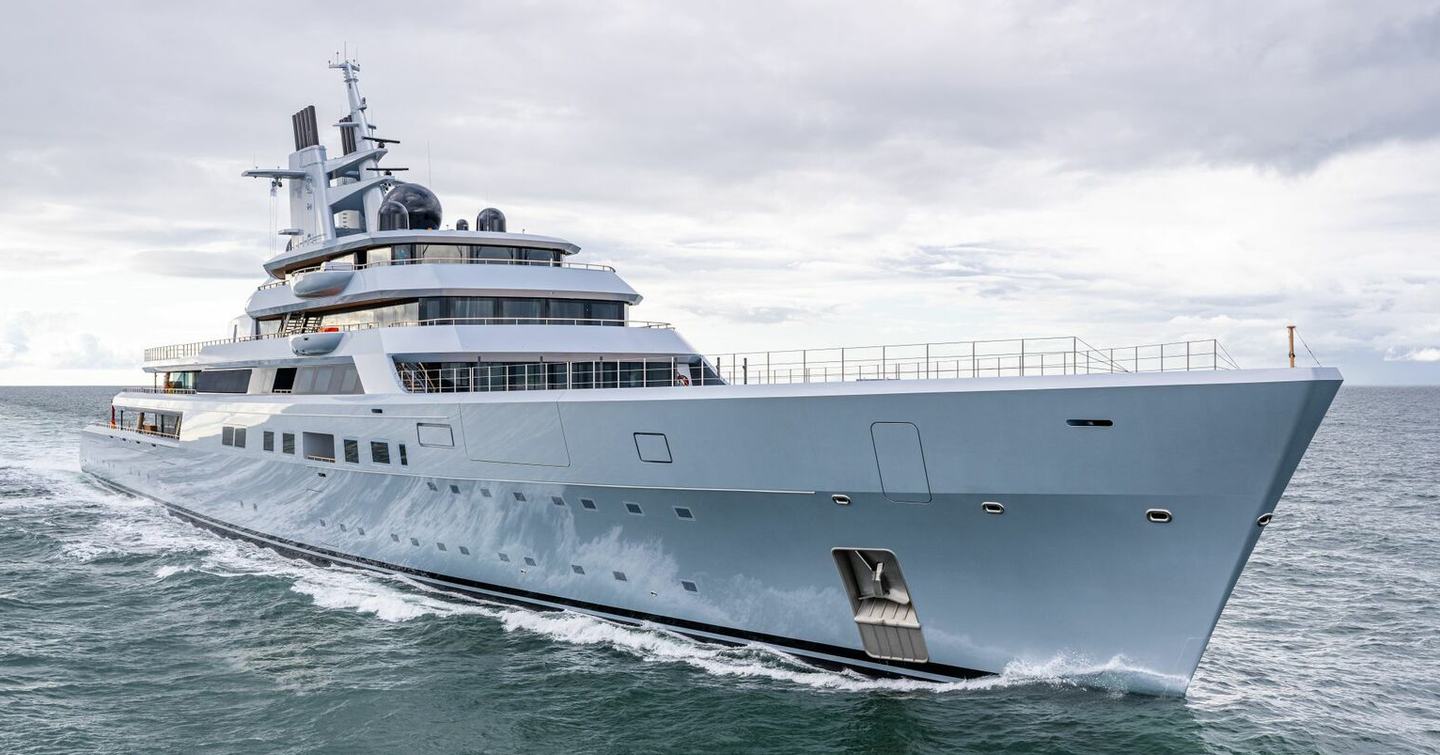 A starboard-side view of Lurssen superyacht Project ALI BABA cutting through grey seas