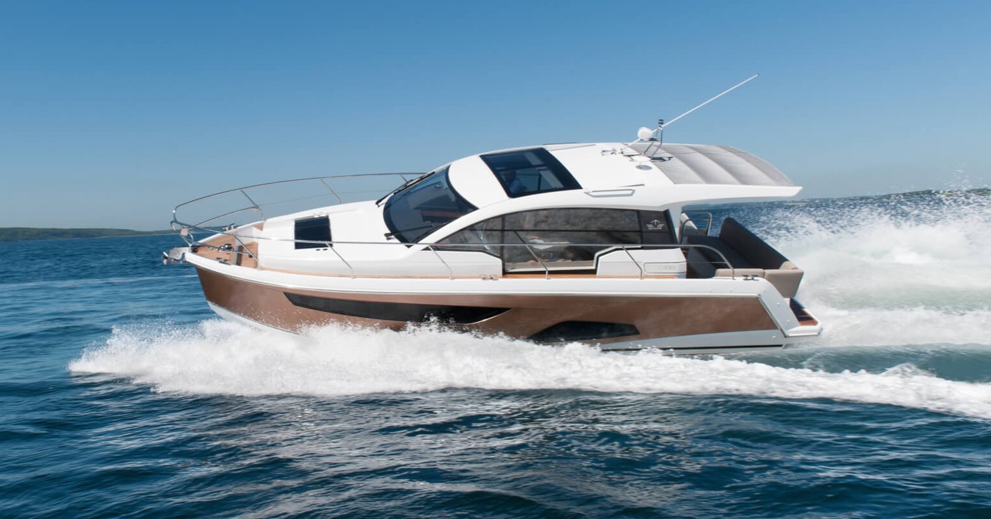 Sealine C330 cruiser underway, surrounded by sea and land in far distance