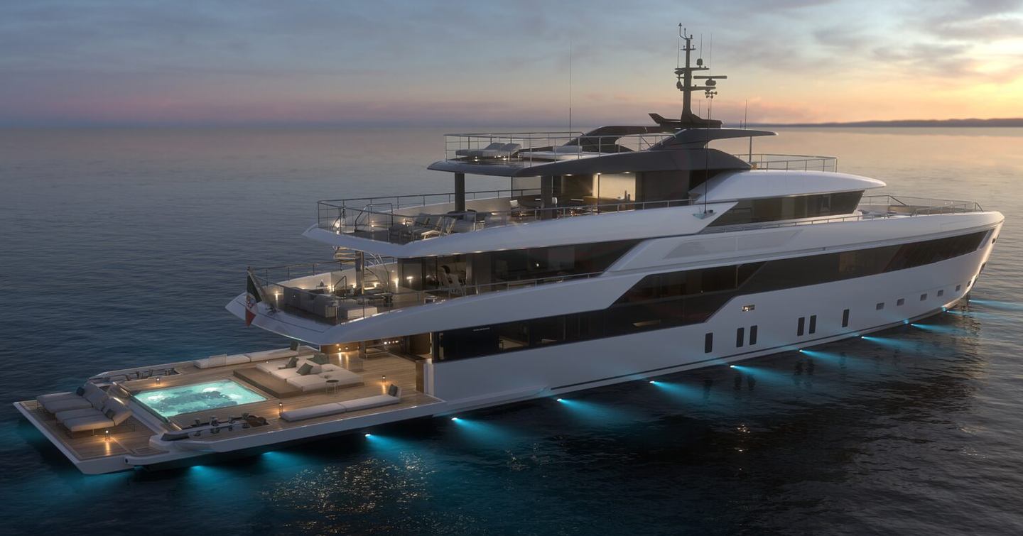 Motor yacht 50Steel at sunset with pool, expansive decks and underwater lights illuminating the sea 